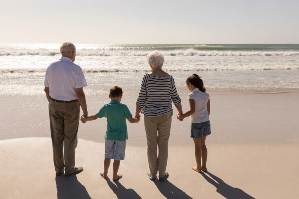 Grandparents and 2 grandkids walking on the beach, representing Grantor Retained Annuity Trust (GRA