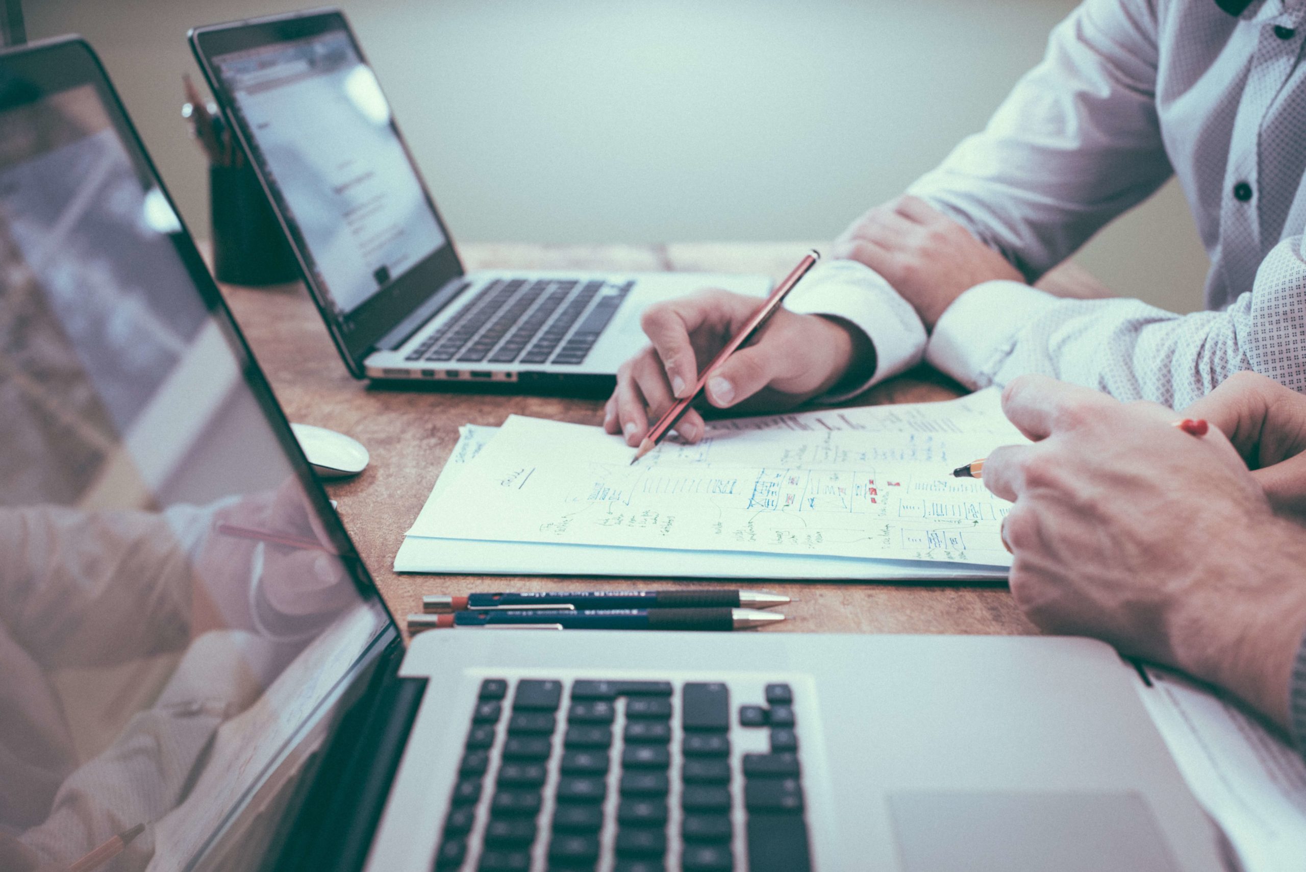 two people looking at paper work, representing determining business valuation