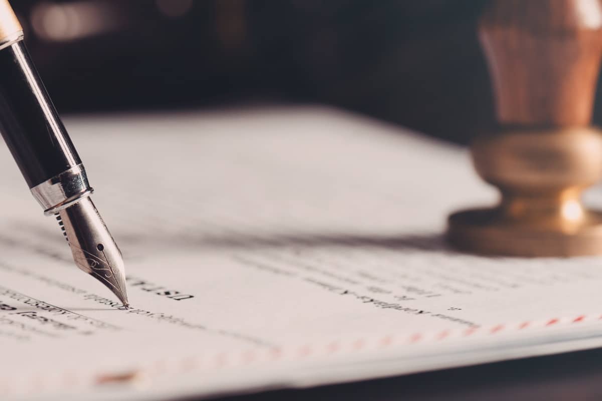 Law theme, fountain pen, paper, and stamp on a desk, representing a Grantor Retained Annuity Trust for Estate Planning