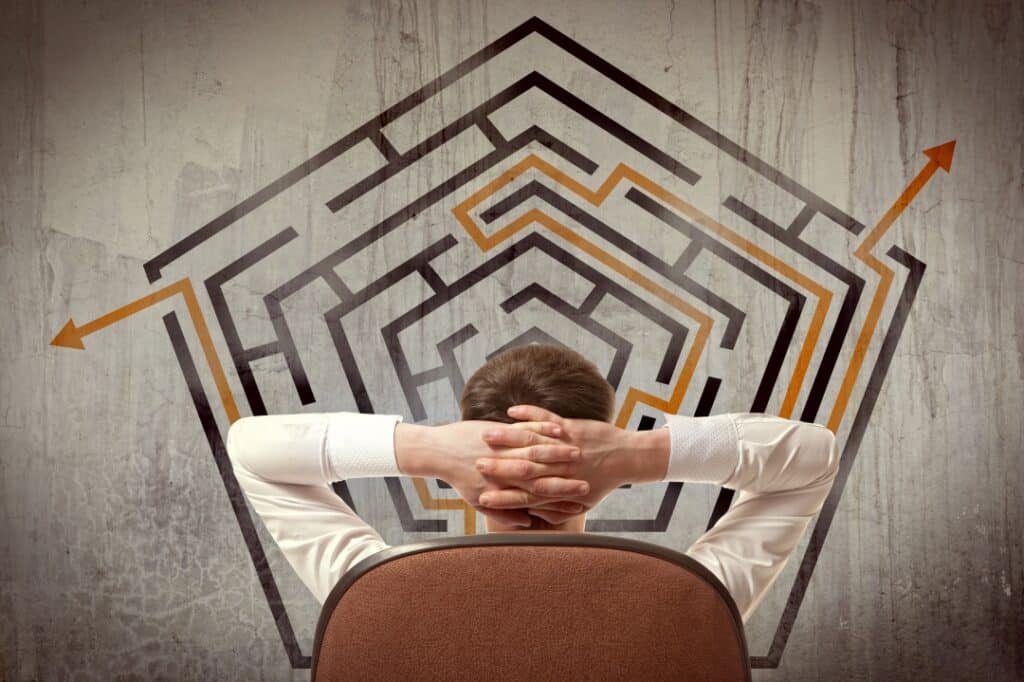 Exit Planning for Business Owners represented by business man looking at a maze